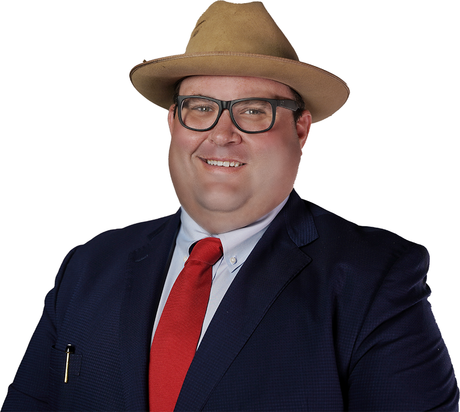 Man with hat in suit and red tie smiling